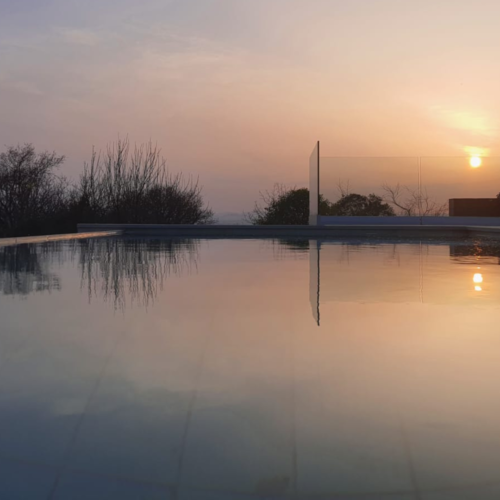 Piscina-infinity-gunitada-gijon-exterior-sunset